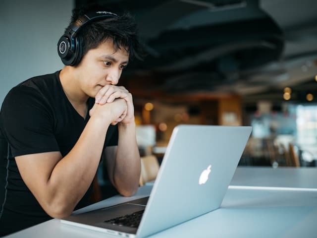 Student with headphones learning from a laptop